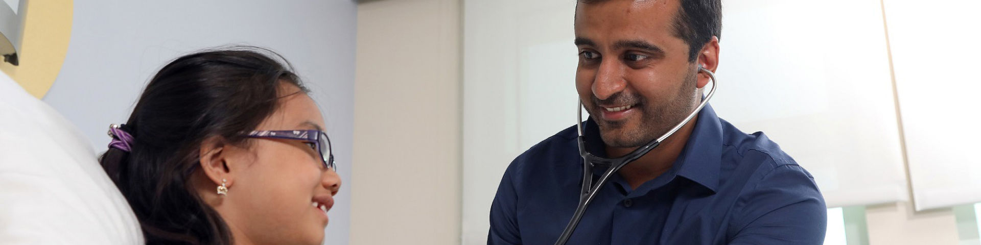 Mukul Sehgal, M.D., with a pediatric patient